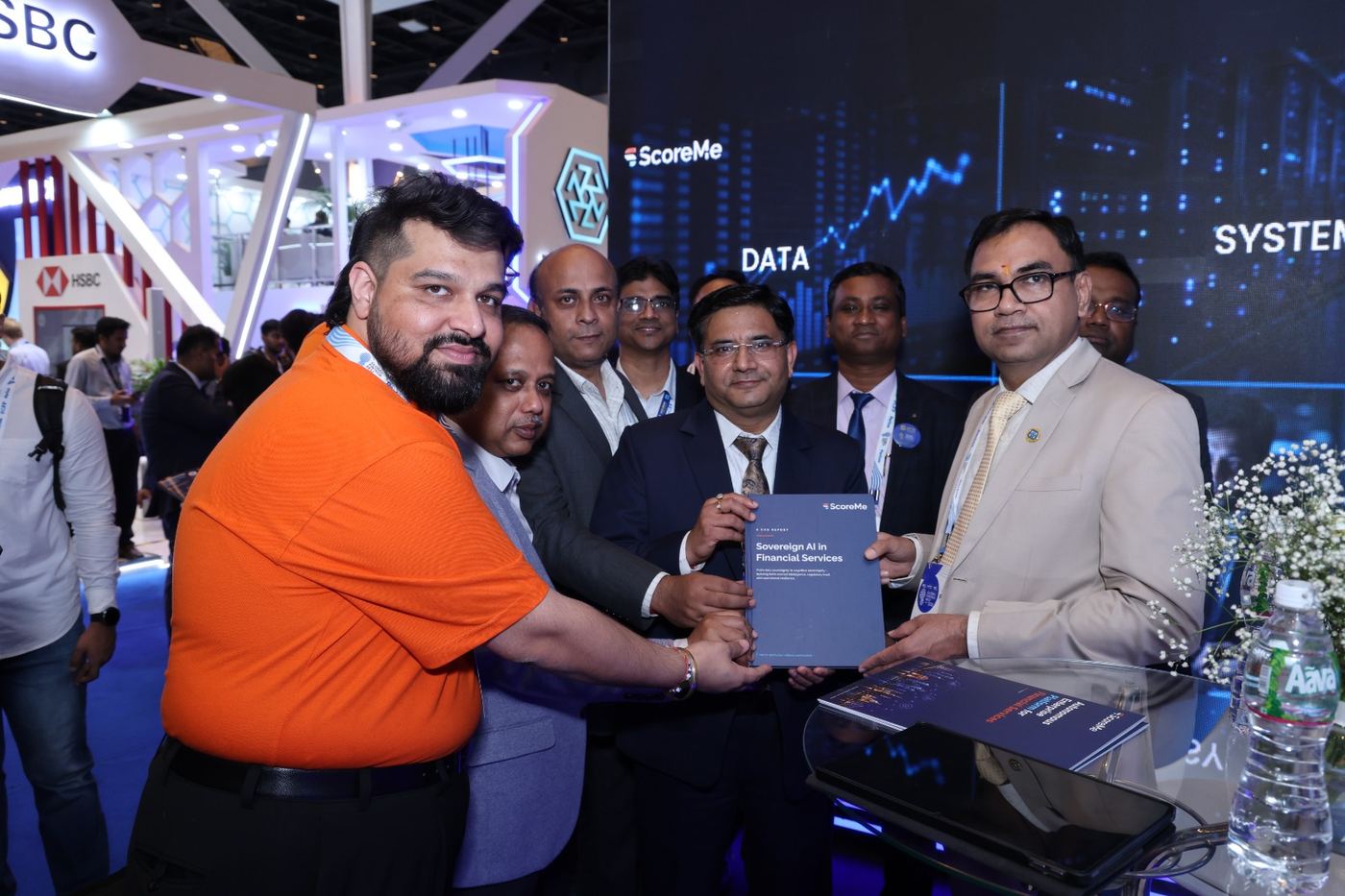 A group of delegates being handed the report at the ScoreMe exhibition stand.